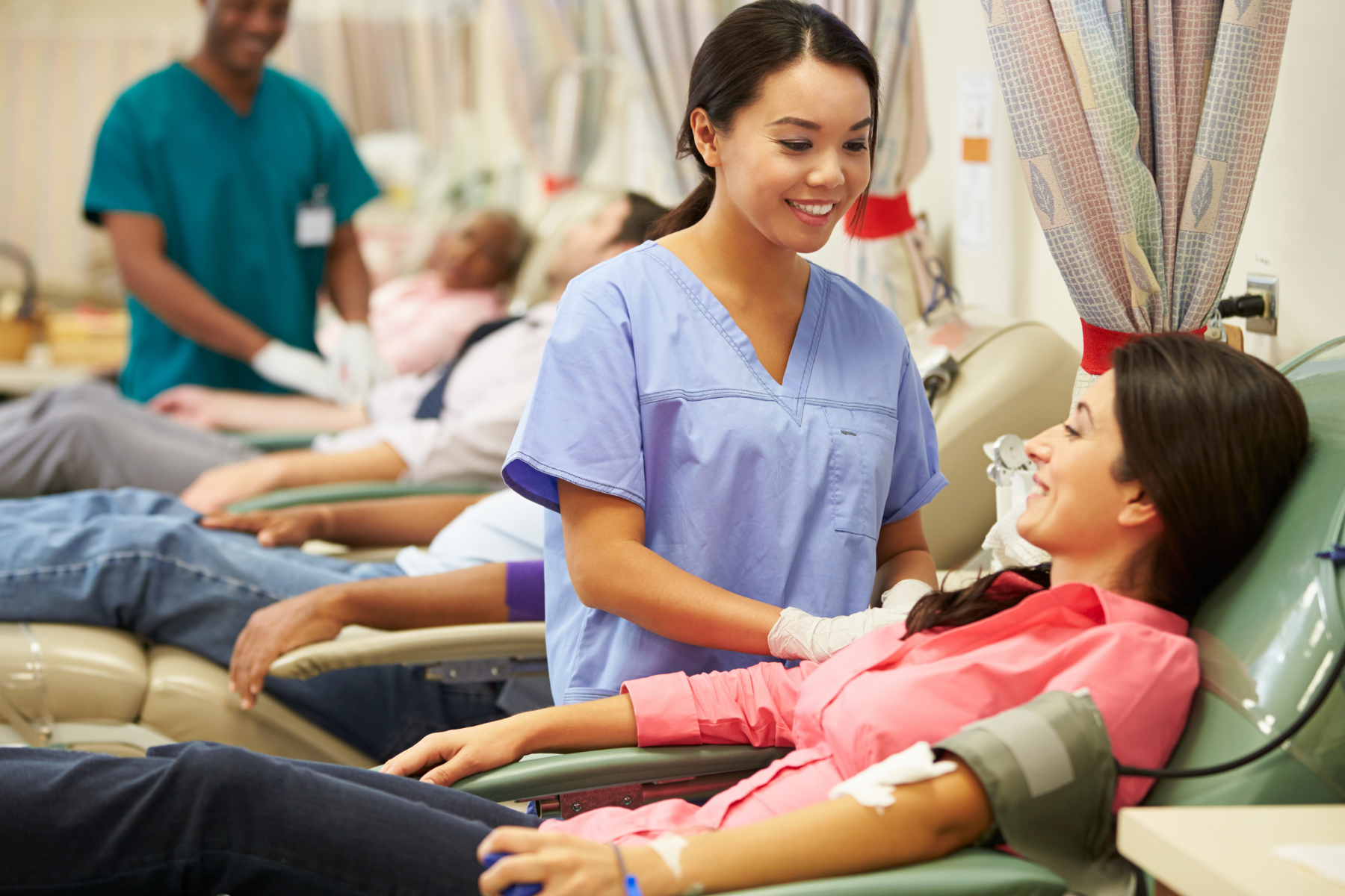 People donating blood at a blood drive.